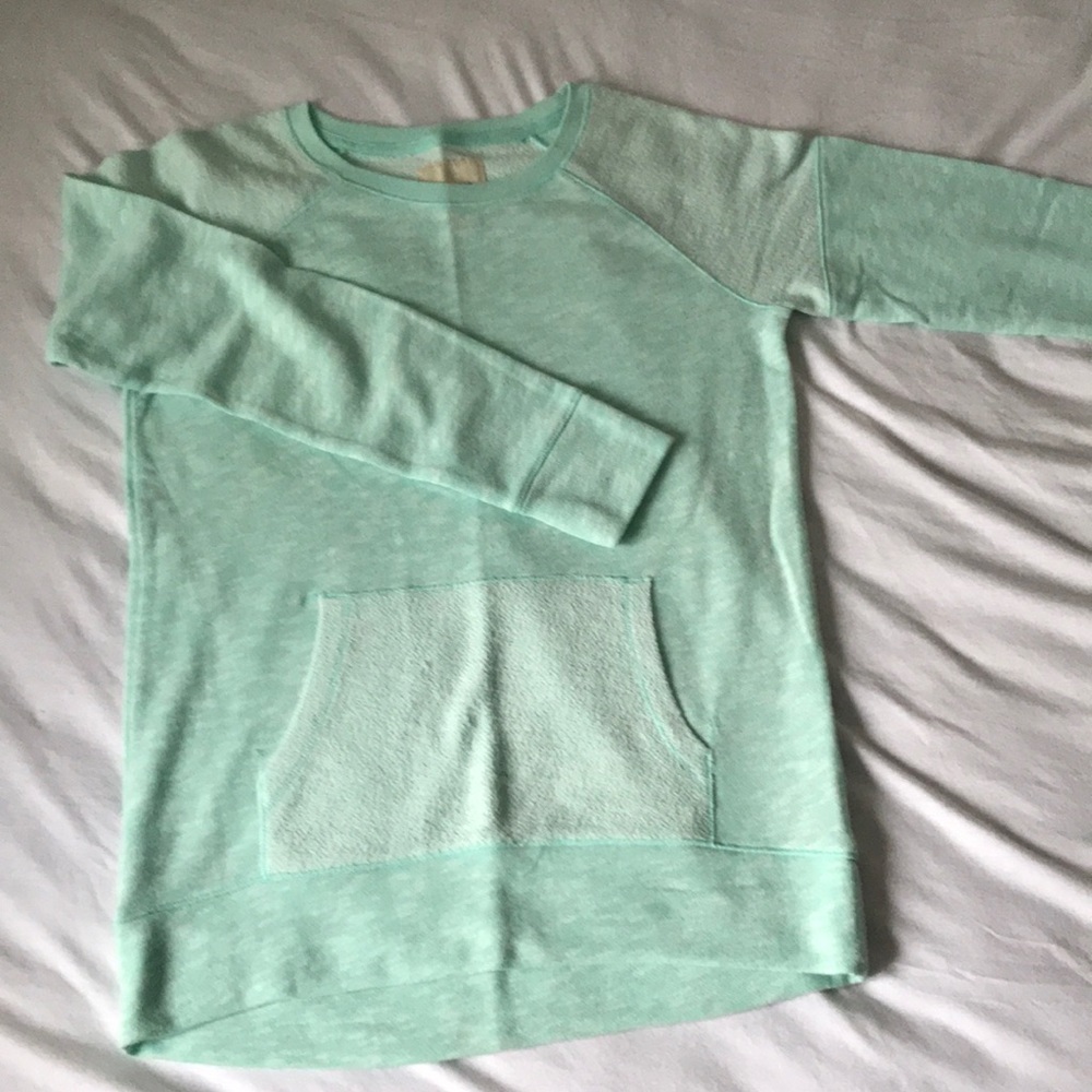 A mint green pullover sweater